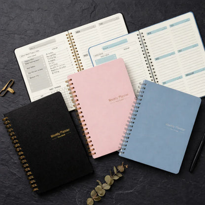 Spiral-bound weekly planners in black, pink, blue with habit tracker, ideal for reducing distractions and boosting productivity
